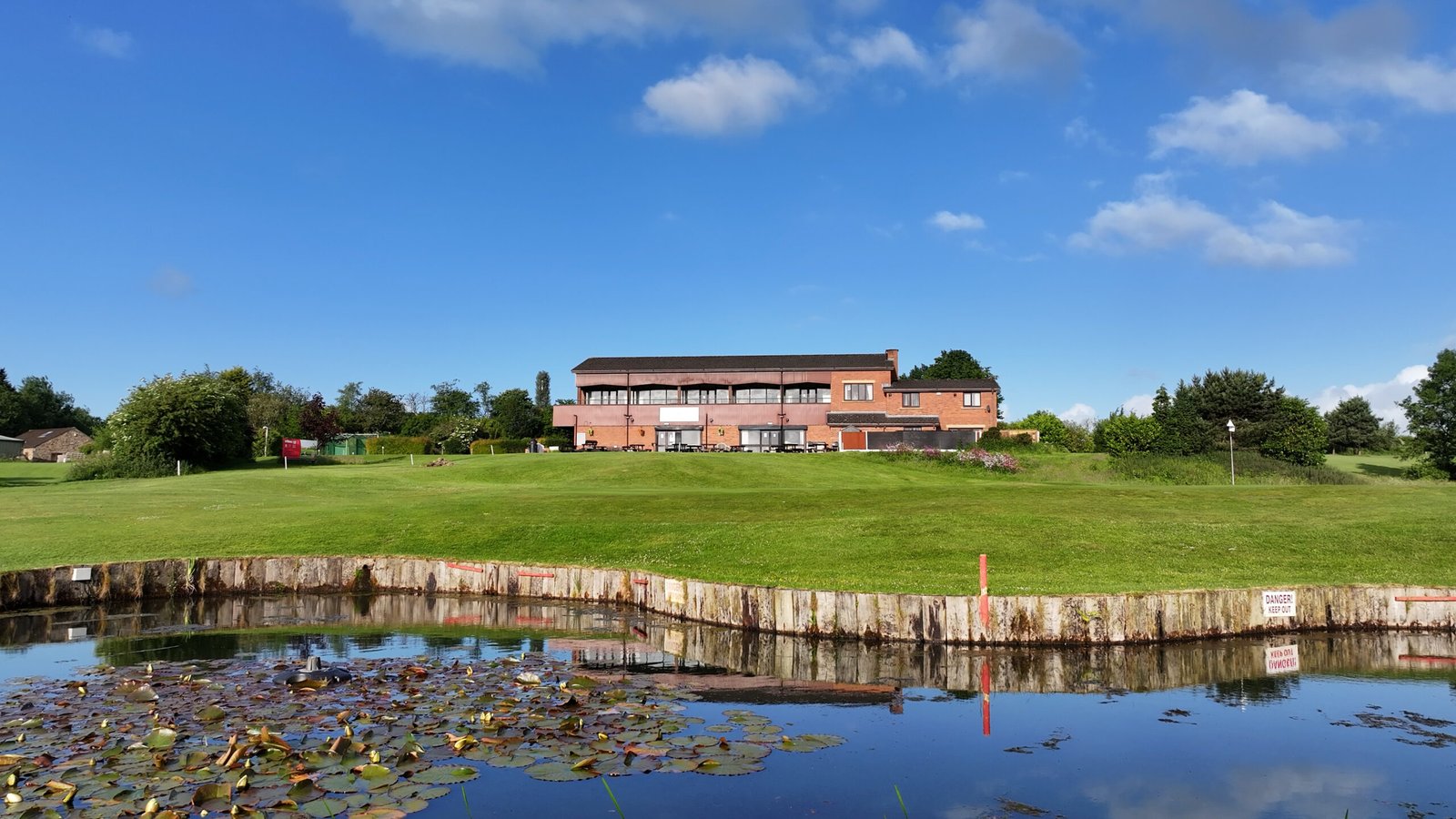 Pond and clubhouse at Great Lever & Farnworth Golf Club
