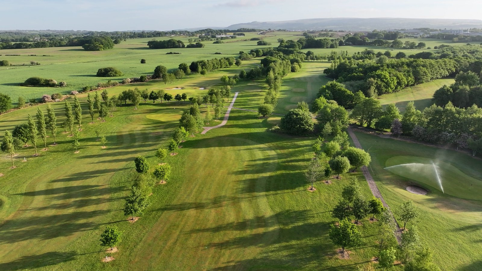 Wide drone shot of rolling fairway at Westhoughton Golf Club